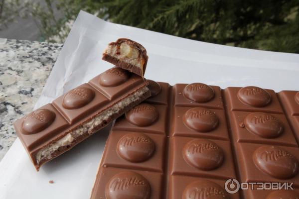 Шоколад молочный Milka с молочной и карамельной начинками и цельным фундуком фото